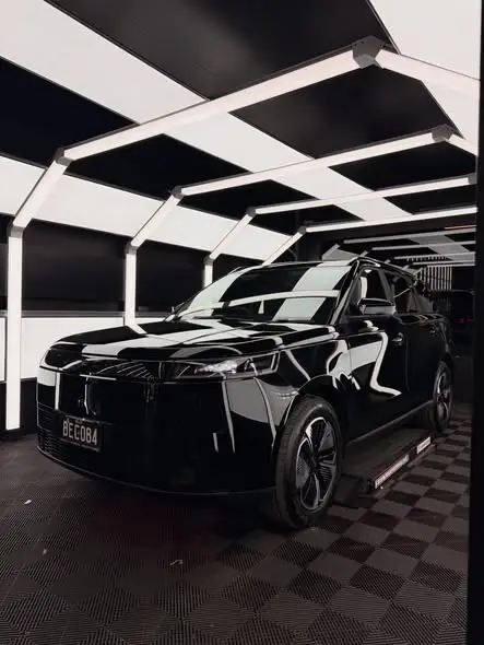 Black SUV with a deep gloss finish in the studio